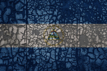 flag of nicaragua on a old grunge metal rusty cracked wall background