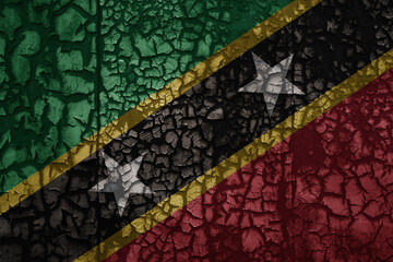 flag of saint kitts and nevis on a old grunge metal rusty cracked wall background