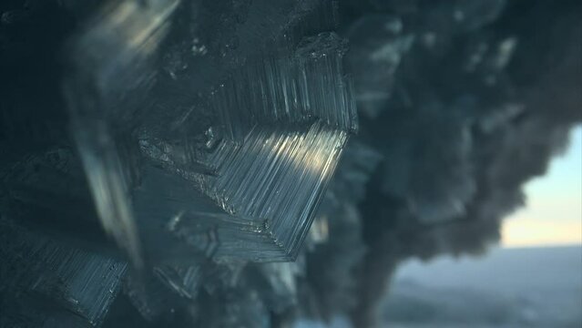 Close up ice crystal, sharp ice snowflakes on stalactites inside frozen cave 