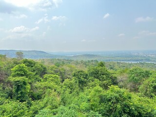 View from the top of the mountain with lush green trees.
