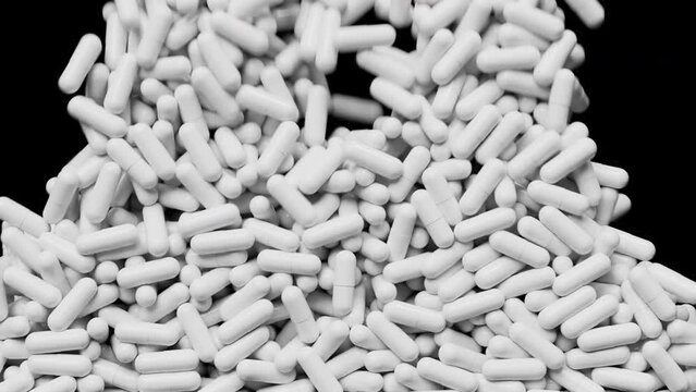 White pills fall down and fill screen area. Medicine capsules backdrop. Pharmacology concept. 3d render animation