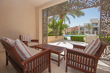Patio terrace garden with chairs in tropical luxury apartment resort