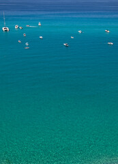 Sea beach with turquoise water and sand where people relax