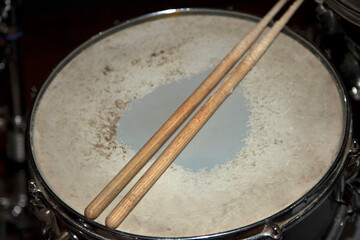 Old bass drum and drumsticks