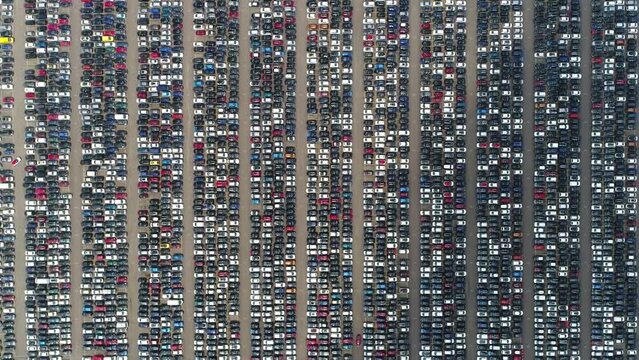 Aerial top down view of automaker car lot showing vehicles parked close to each other ready for further distribution the automotive industry is one of worlds most important economic sectors by revenue