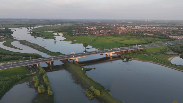 Aerial hyperlapse of the Jan Blankenbrug is a bridge over the Lek near Vianen showing the A2 highway. Dutch infrastructure, trasnportation over road and water. Time lapse.