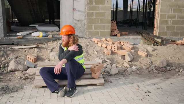 Construction worker with pain accident fall of scaffolding and broken hand, foreman help engineer on building site. Health insurance concept.