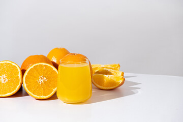 Orange juice in a glass and half a fresh orange, space for text.