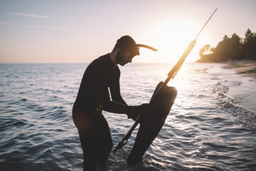 Spearfisherman preparing to dive into water