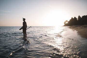 Silhouette of spearfisherman in the sea