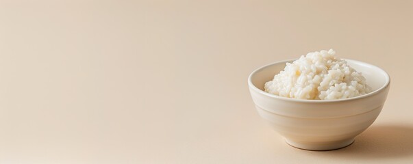 Rice pudding in bowl on beige background with copy space