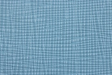 Light blue leather as background, top view