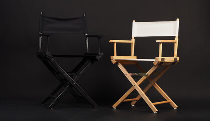 Two director chairs on black background.