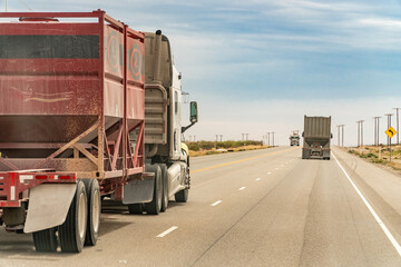 Midland, TX, US-March 31, 2024: Trucks driving through the Permian Basin fracking area.