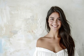 Fototapeta premium A woman with long hair is smiling and wearing a white dress. Concept of happiness and positivity