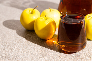 Apple juice in a glass and jug on a white background
