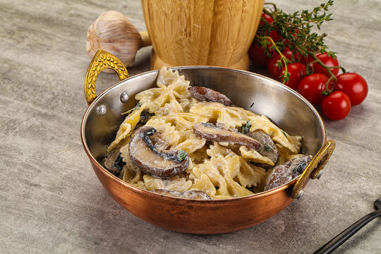Italian cuisine - farfalle with mushrooms