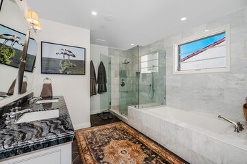 a very clean and bright bathroom with a bathtub and a sink
