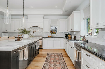 this white kitchen has wood floors and an oriental runner rug