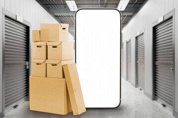 Self storage unit. Phone mock up. Cardboard boxes in warehouse corridors. Smartphone with blank...