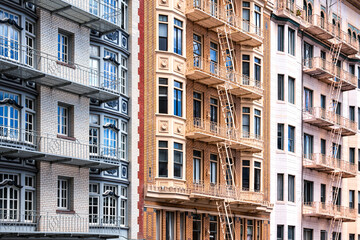 Facades of typical inner-city residential buildings from the turn of the century in San Francisco,...
