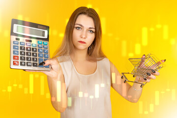 Bankrupt woman. Calculator in hands of poor lady. Girl lost her livelihood. Bankrupt woman standing on yellow. Empty supermarket cart is metaphor for bankruptcy. Price growth charts near buyer