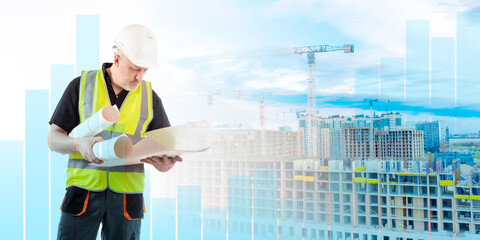 Man builder. Architect with paper drawings. Construction worker near fluctuating chart. Engineer guy thought about it. Builder stands near buildings under construction. Man builder in yellow vest