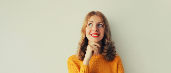 Pensive caucasian young woman thinks looking up - Powered by Adobe