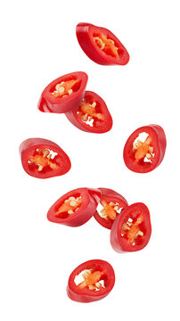 Falling sliced red hot chili peppers isolated on white background