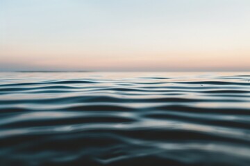 Obraz premium A serene body of water reflects the ever-changing colors of the sky in the background, creating a mesmerizing and harmonious scene.