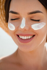 Suntan Lotion Woman Applying Sunscreen Solar Cream on Face