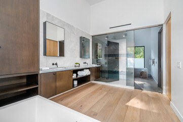 a bathroom with a walk - in shower and double sinks