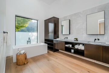 a large bathroom with large mirrors, wood cabinets and sinks