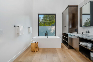 a bathroom with a wooden stool, sink and mirror, along with the tub area