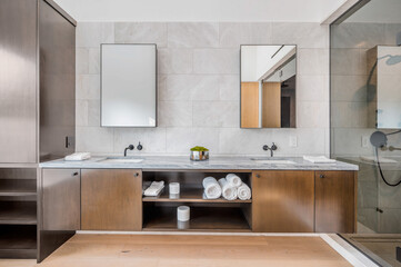 a large modern bathroom with two sinks and a shower area