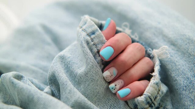 Beautiful summer manicure. Nail design with blue pattern.