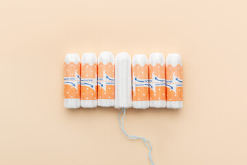 Tampons on a beige background. Feminine hygiene products. Period. Menstrual cycle, pad. Top view. Space for text.