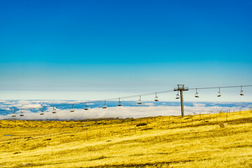 Fototapeta premium Empty chair lift in mountain, Serra da Estrela in Portugal. Timelapse
