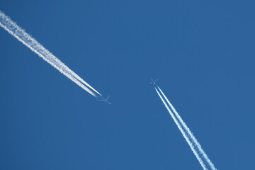 two planes in the sky, two parallel airplane tracks in the blue sky, contrails