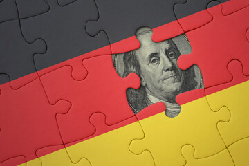 puzzle with the national flag of germany and usa dollar banknote. finance concept