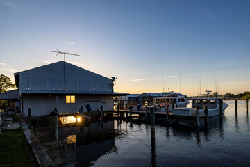 Solomons, Maryland USA A wooden boathouse on the shore of the Patuxent River at daybreak.