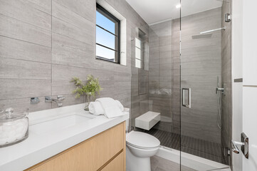the bathroom with a glass shower and a wooden counter top