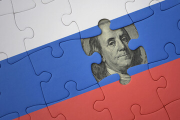 puzzle with the national flag of russia and usa dollar banknote. finance concept