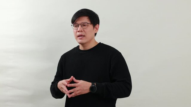 Handsame man talking - Portrait Asian man with dioptrical glasses talking on white background studio