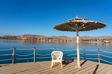 Fototapeta premium Sharm El-Sheikh, Egypt sea beach umbrella mountain seascape.