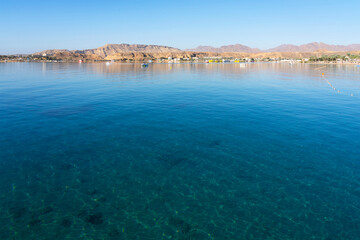 Sharm El-Sheikh, Egypt: blue water of Red sea beach coastal mountain view.