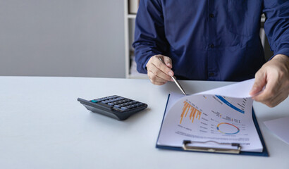 Businessman analyzing company financial report, balance sheet, working with document graphs Save...