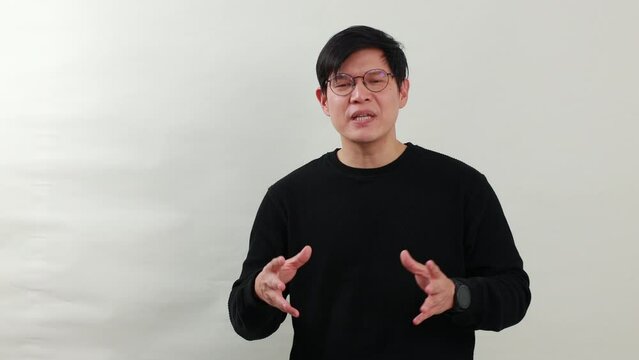 Handsame man talking - Portrait Asian man with dioptrical glasses talking on white background studio