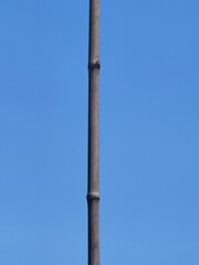 Fototapeta premium a vertical shot of a street pole on a blue sky background