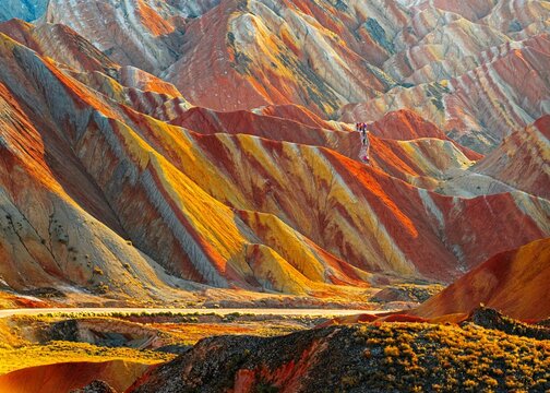 Amazing scenery of china mountains and blue sky background in sunset. Zhangye Danxia National Geopark, Gansu, China. Colorful landscape, rainbow hills, unusual colored rocks, sandstone erosion - Powered by Adobe